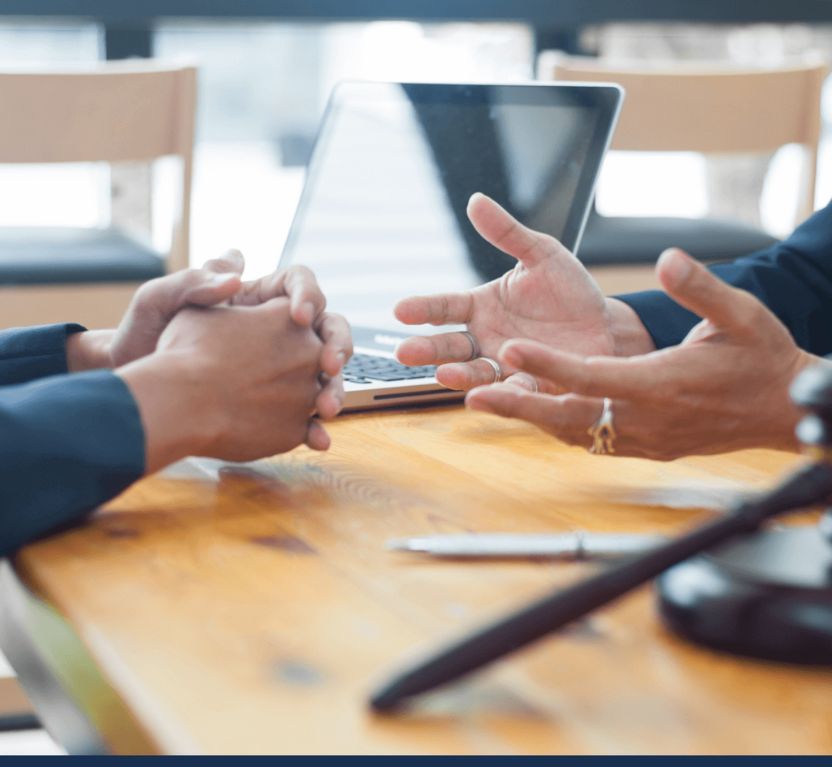 Two individuals discussing a insurance case
