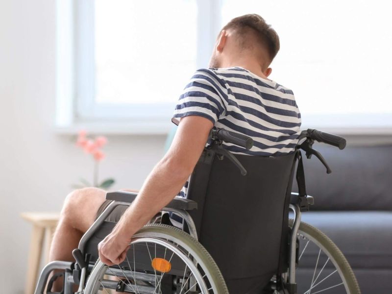 a man in a wheelchair in a living room
