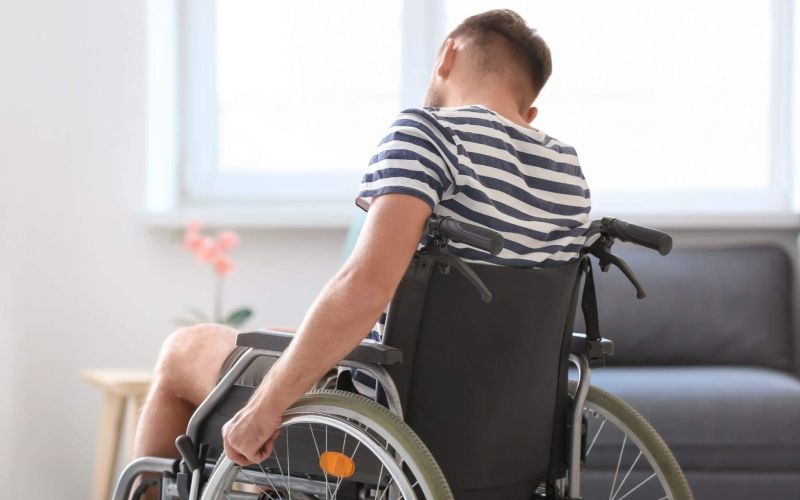 a man in a wheelchair in a living room