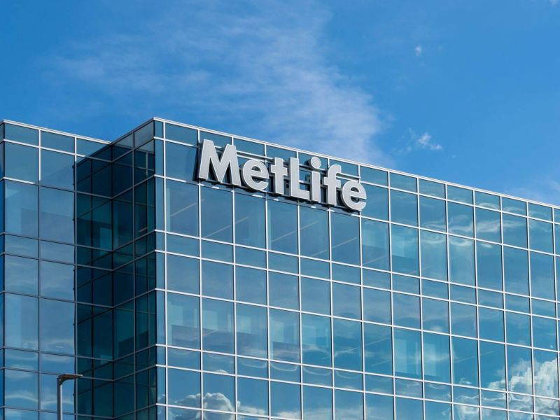 a large glass building with a sign on top of it