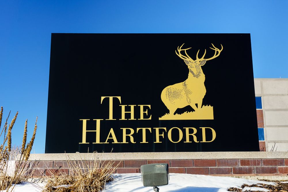 The Hartford sign with gold stag logo against blue sky, representing the insurance company branding.