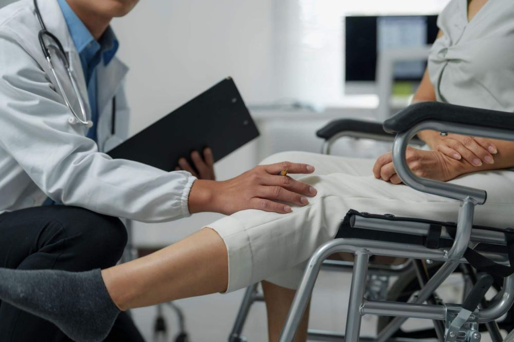 a doctor and a patient sitting in a chair
