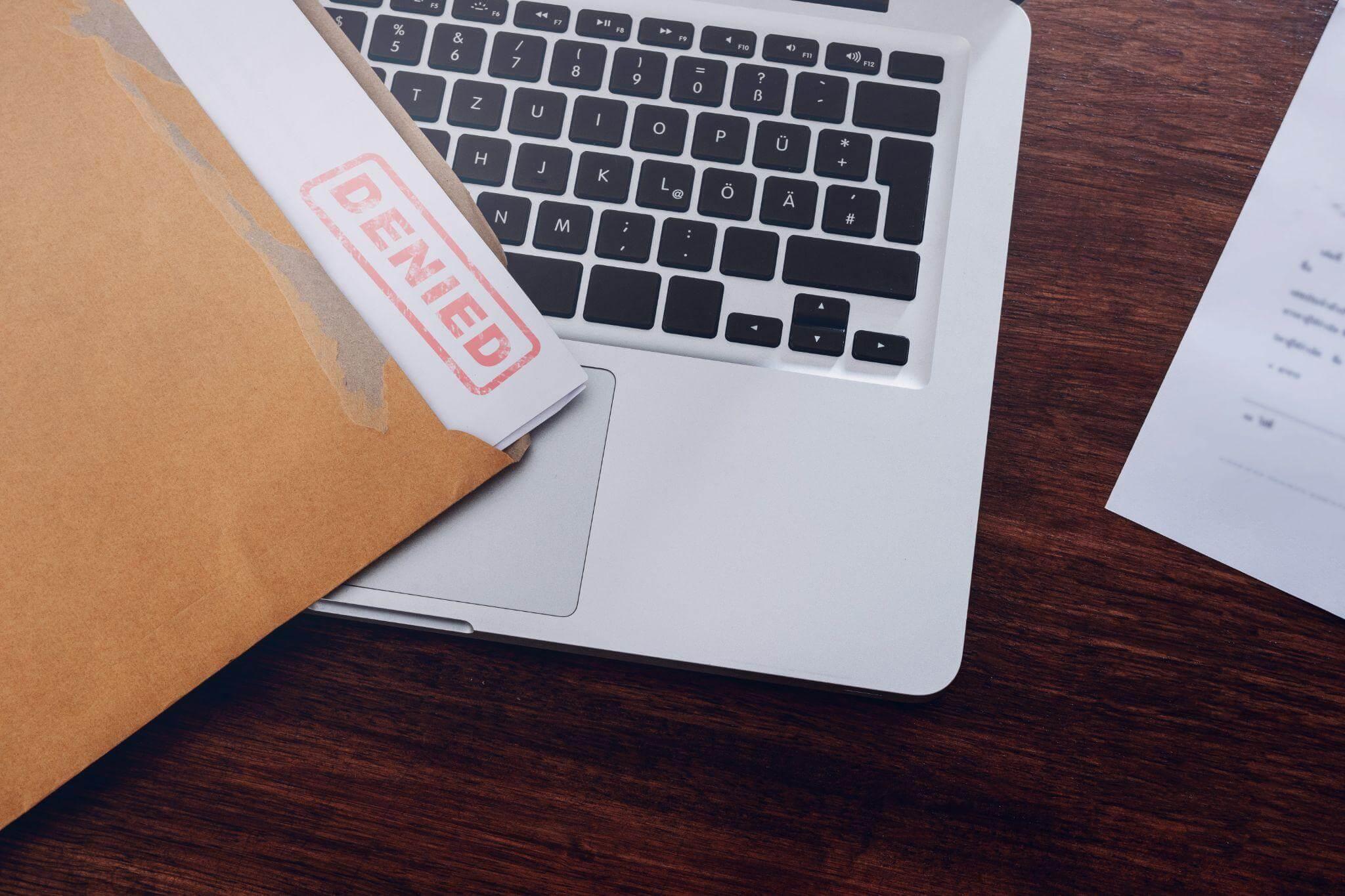 a laptop computer sitting on top of a wooden desk
