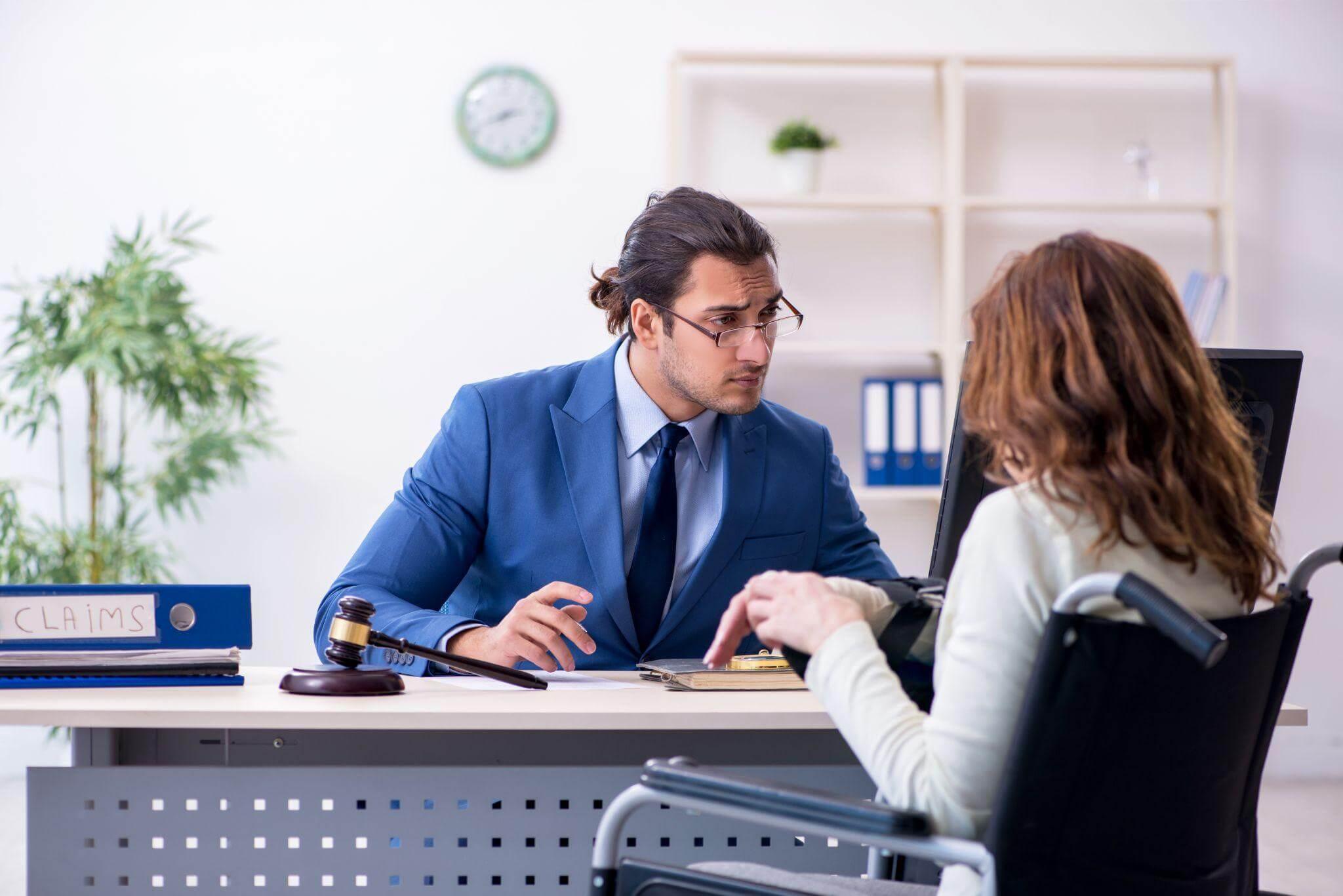 a man in a suit and tie sitting at a desk with a woman