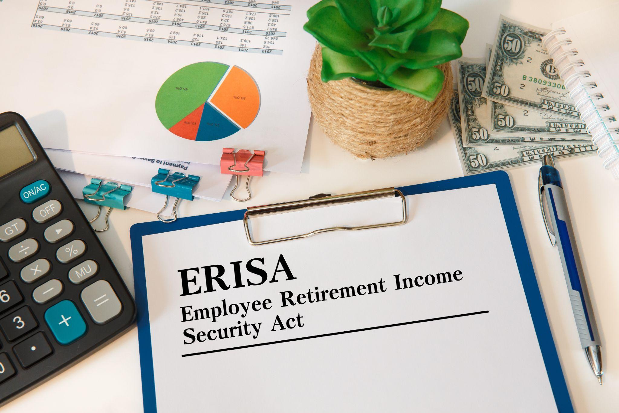 Clipboard with ERISA retirement income security documents beside financial charts, cash, calculator, and office supplies.