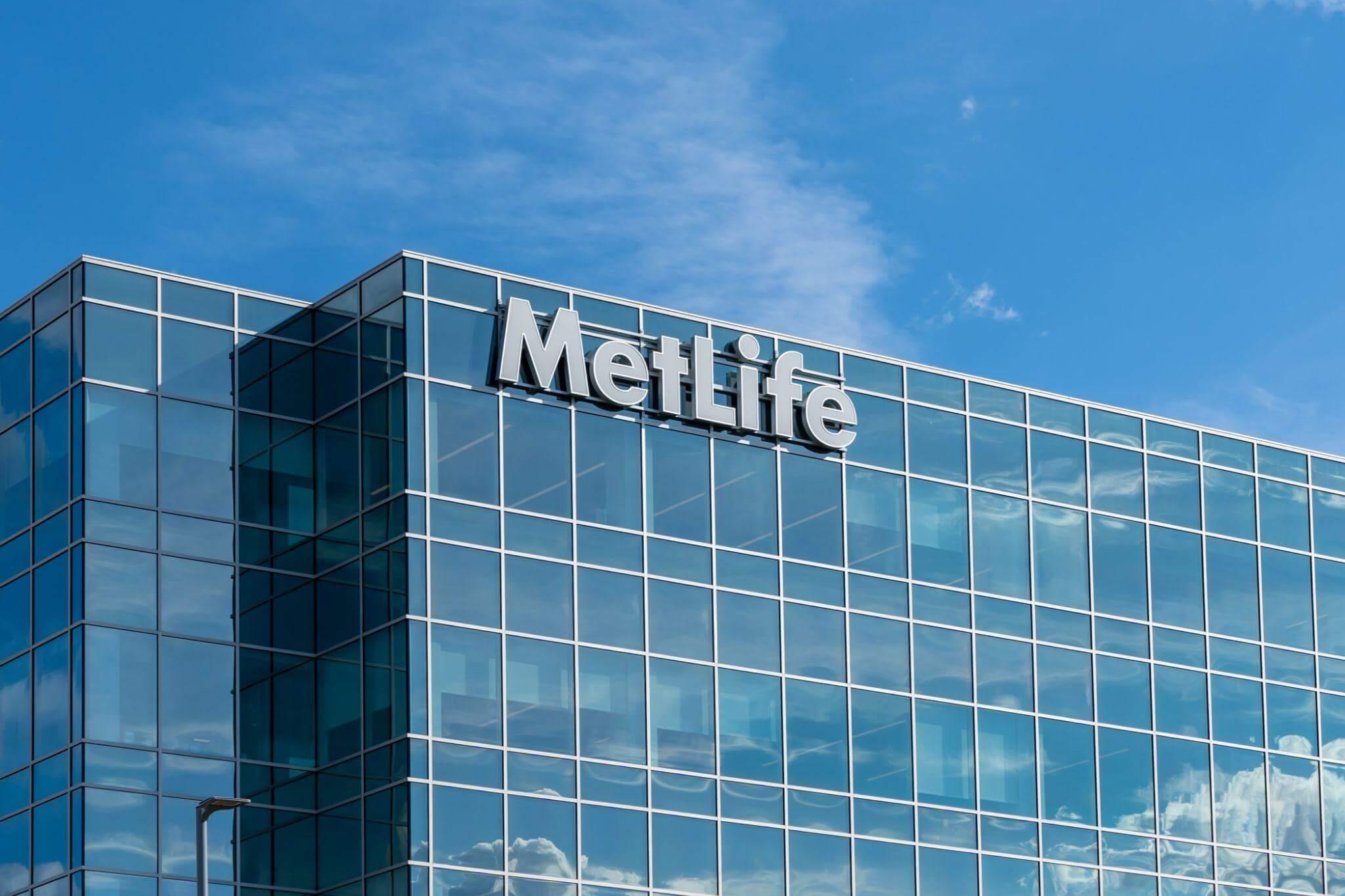 a large glass building with a sign on top of it