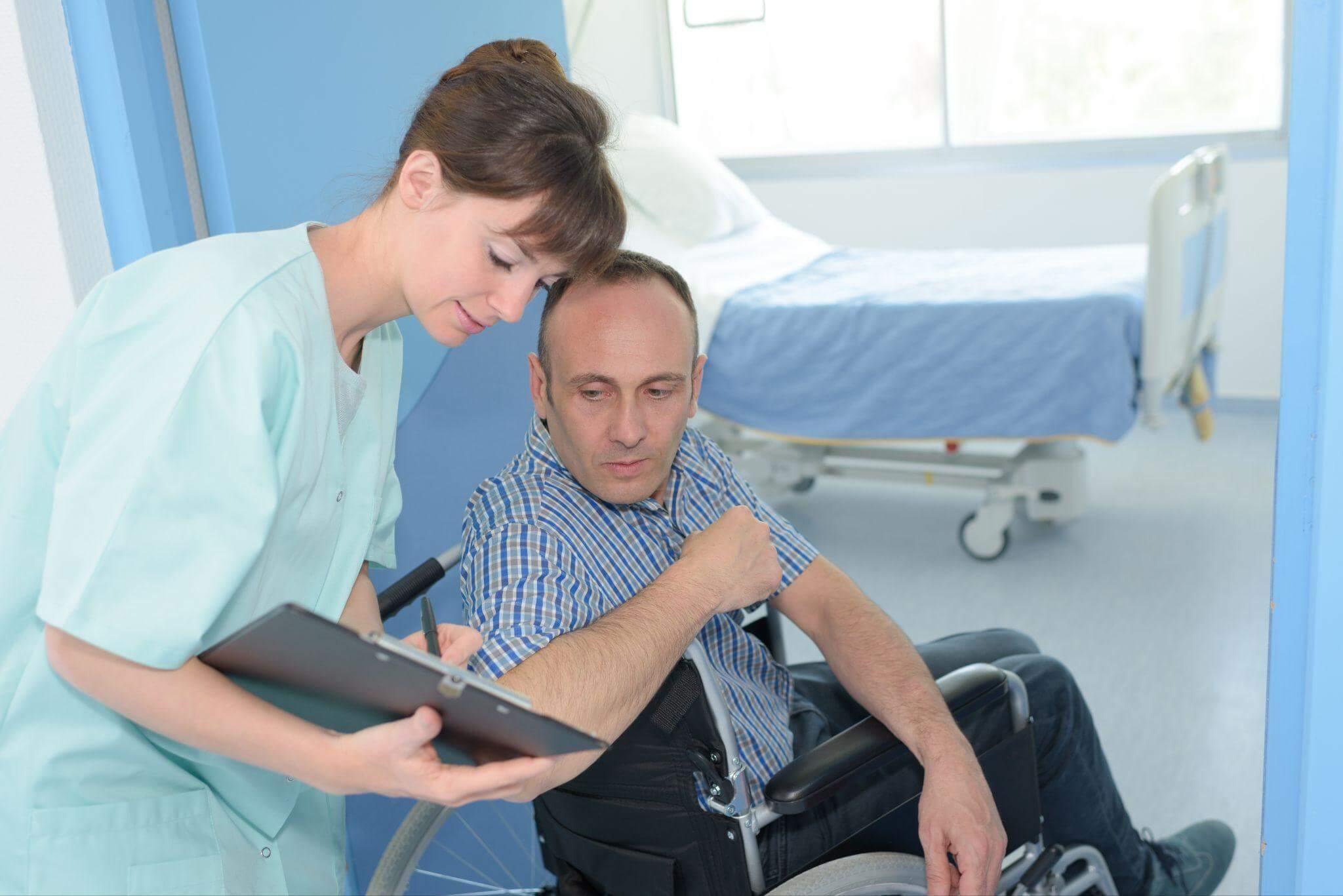 a man sitting in a wheel chair next to a woman