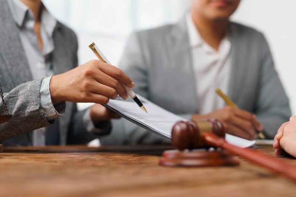 Three people reviewing documents related to ERISA litigation